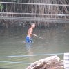 boy in river which leads into ocean