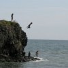 local boys jumping off of the "pig" into the ocean