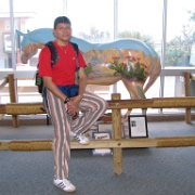 Francisco poses with wooden horse in the exhibits building